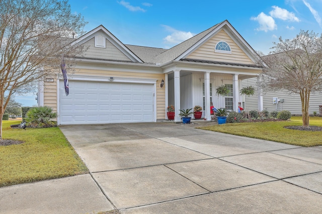 view of front of property with a garage, a front yard, and a porch