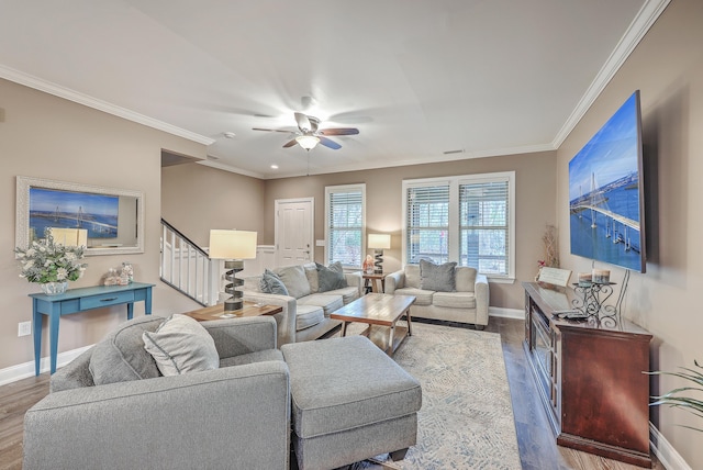 living room featuring ornamental molding, ceiling fan, and dark wood-type flooring