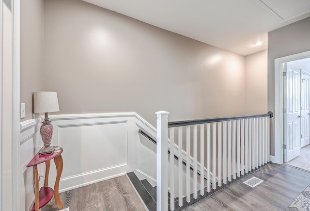 stairway with hardwood / wood-style floors