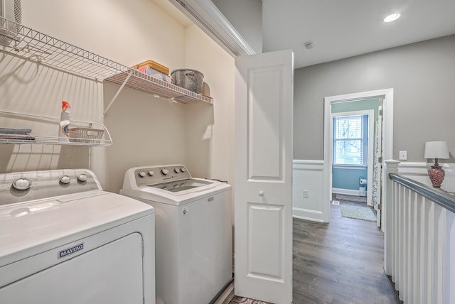 washroom with dark hardwood / wood-style floors and washing machine and clothes dryer