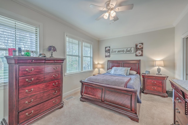 bedroom featuring ornamental molding, light colored carpet, and ceiling fan