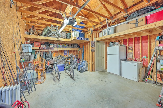 interior space with a garage door opener, fridge, and white fridge