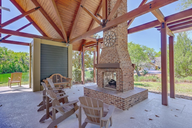 view of patio / terrace featuring an outdoor brick fireplace