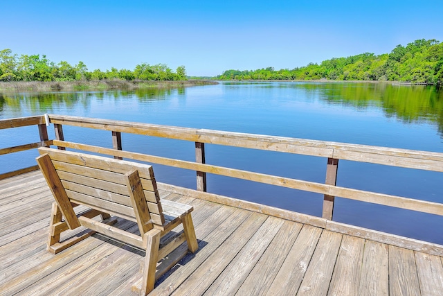 view of dock with a deck with water view