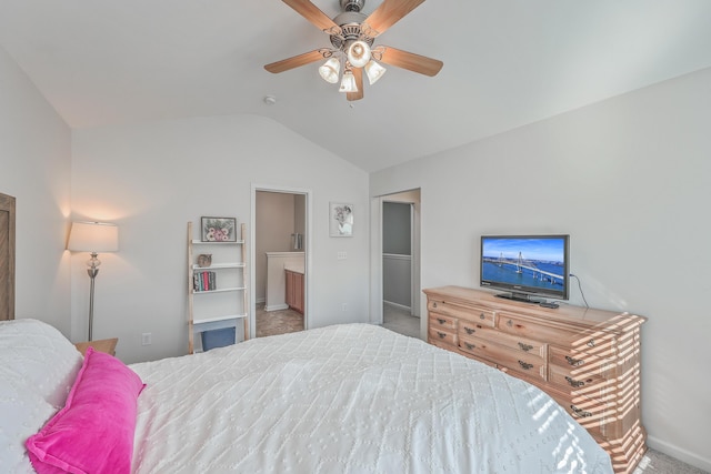 carpeted bedroom featuring ensuite bath, ceiling fan, and lofted ceiling