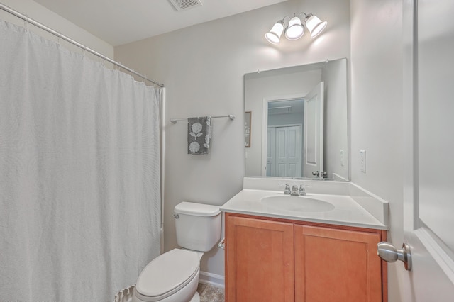 bathroom featuring vanity, toilet, and walk in shower