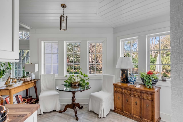 sunroom / solarium featuring lofted ceiling