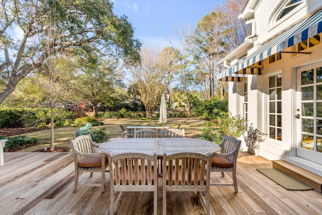 wooden deck featuring entry steps and outdoor dining area