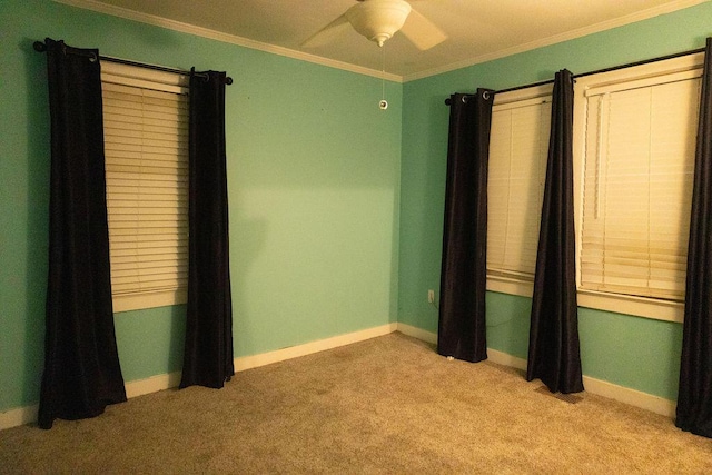 unfurnished room featuring ceiling fan, light colored carpet, and ornamental molding