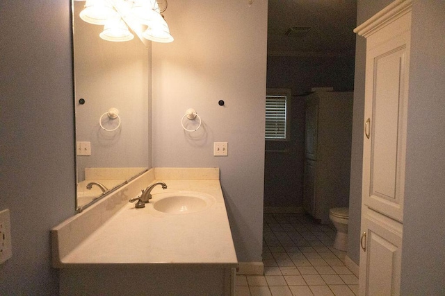 bathroom featuring tile patterned flooring, vanity, a chandelier, and toilet