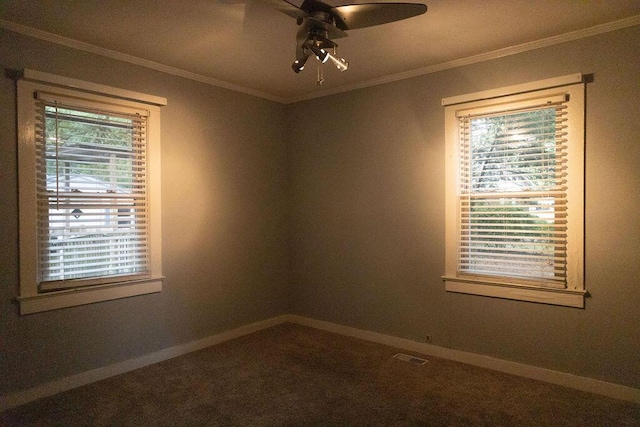 empty room featuring carpet, plenty of natural light, ornamental molding, and ceiling fan