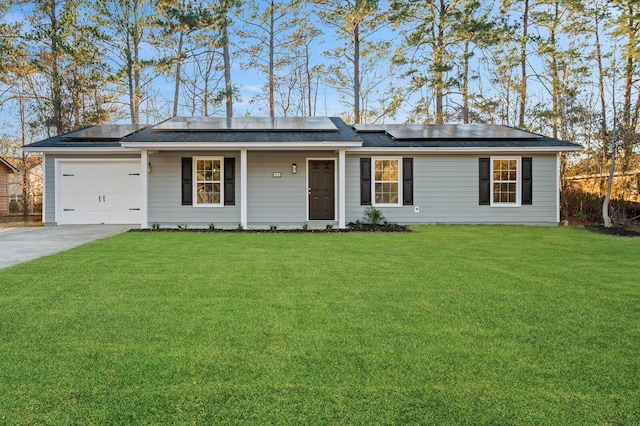 ranch-style home featuring a front yard, solar panels, and a garage