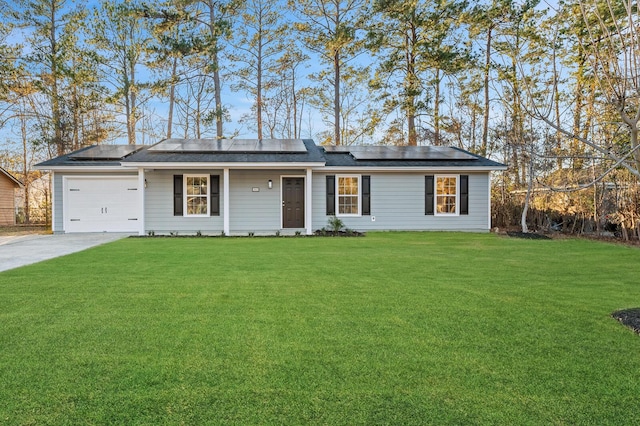 single story home featuring solar panels, a garage, and a front yard