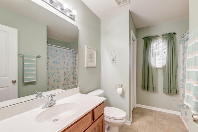 bathroom featuring tile patterned flooring, vanity, and toilet