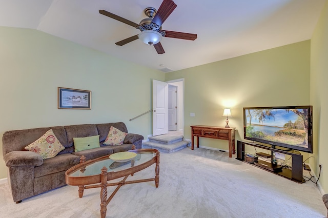 living room with vaulted ceiling, light colored carpet, and ceiling fan