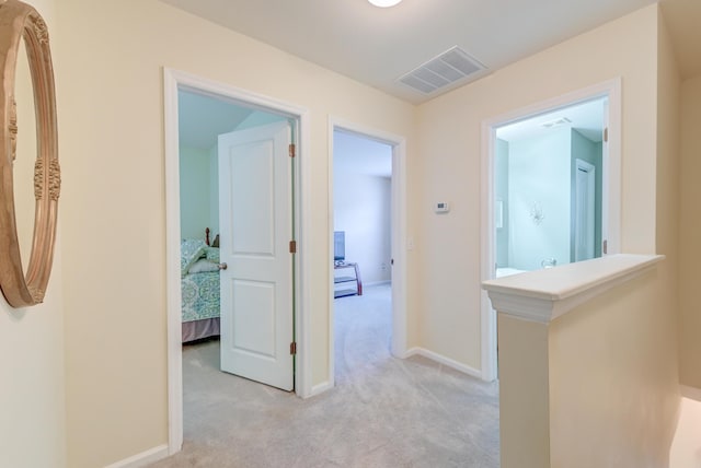 corridor with light colored carpet