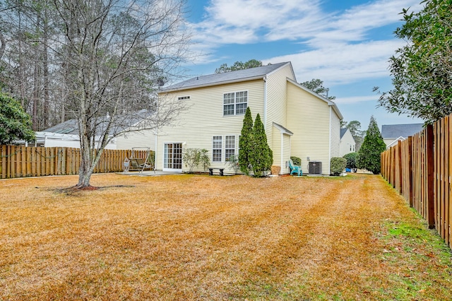 rear view of house with a patio area, central air condition unit, and a lawn