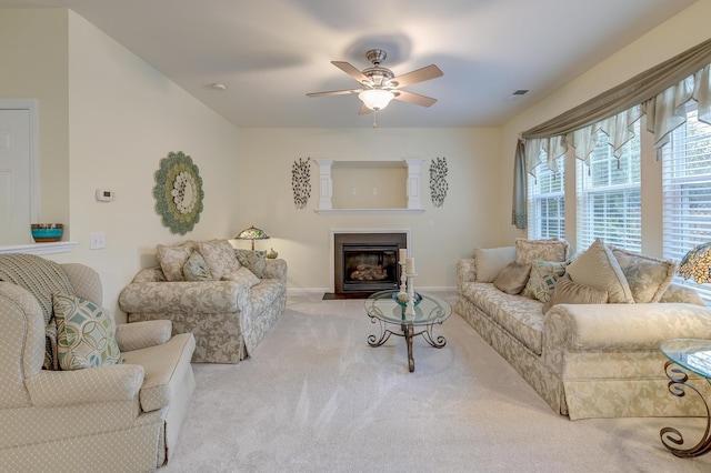 carpeted living room with ceiling fan