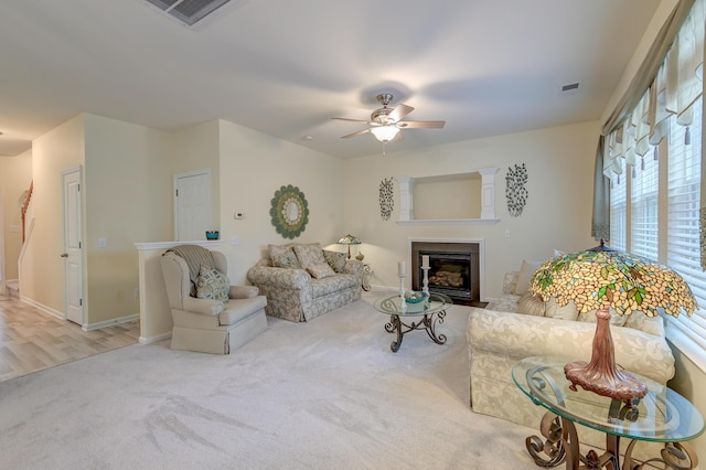 living room with ceiling fan and light colored carpet