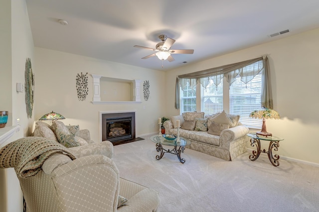 carpeted living room with ceiling fan