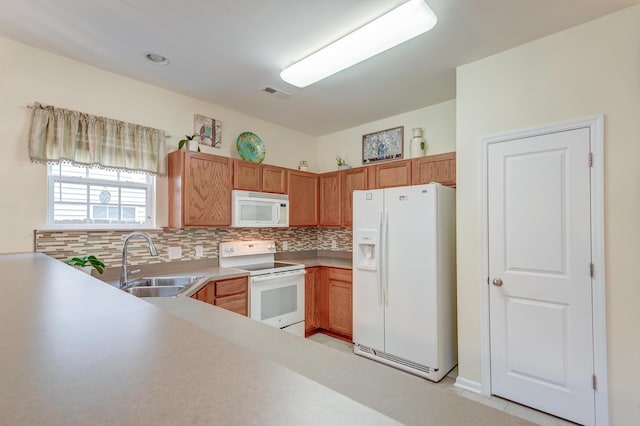 kitchen with white appliances, sink, and decorative backsplash