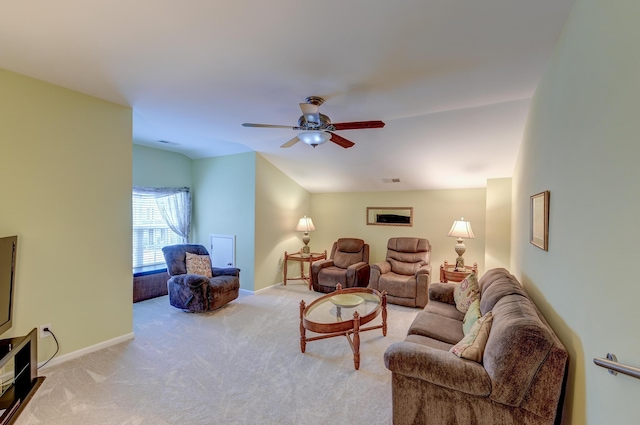 carpeted living room with ceiling fan and vaulted ceiling