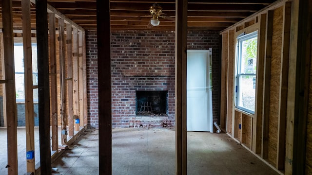 misc room featuring an outdoor brick fireplace and brick wall