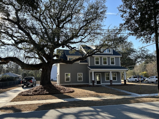 view of front of home featuring concrete driveway and fence