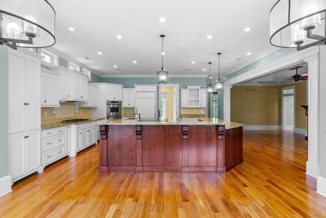 kitchen with crown molding, a healthy amount of sunlight, ceiling fan, and appliances with stainless steel finishes