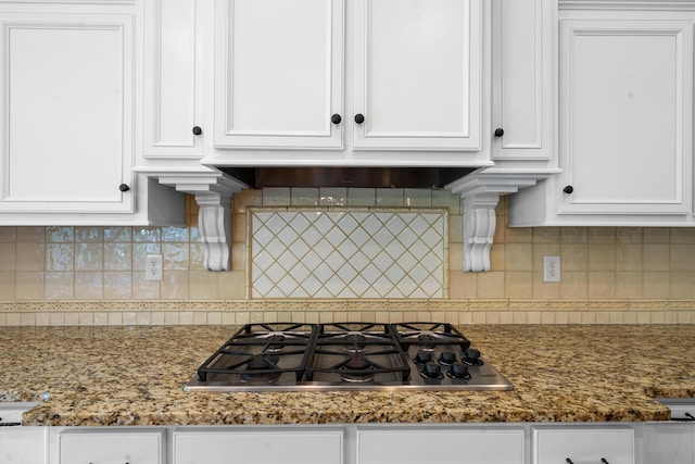 kitchen featuring tasteful backsplash, white cabinetry, and stainless steel gas cooktop