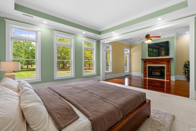 bedroom featuring visible vents, baseboards, crown molding, recessed lighting, and wood finished floors