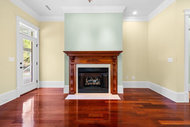 unfurnished living room with visible vents, baseboards, ornamental molding, and wood finished floors