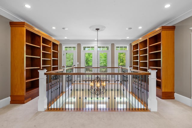 interior space with carpet floors, an upstairs landing, and plenty of natural light