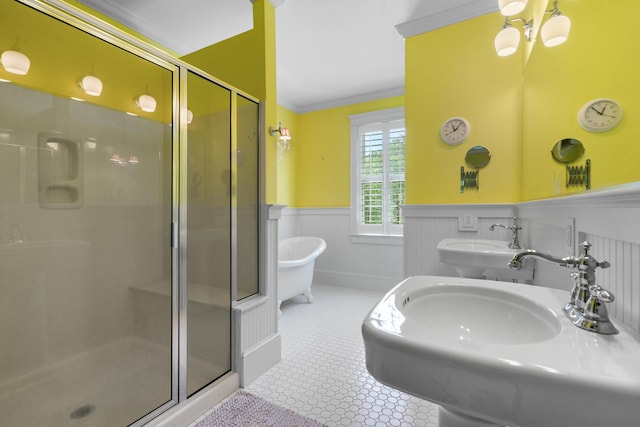full bath featuring a shower stall, wainscoting, a sink, and crown molding