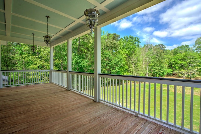 wooden terrace featuring a lawn