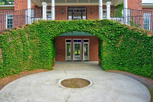 view of exterior entry with brick siding