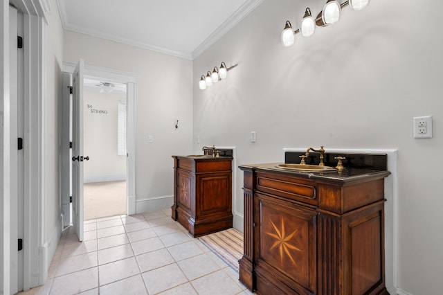 bathroom with a sink, ornamental molding, two vanities, and tile patterned flooring