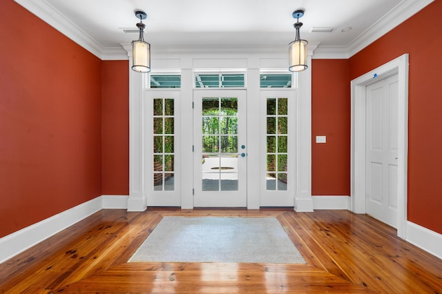 entryway with parquet flooring, visible vents, baseboards, and ornamental molding