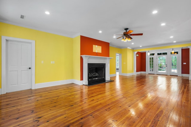 unfurnished living room featuring light wood finished floors, baseboards, a ceiling fan, and a fireplace with raised hearth