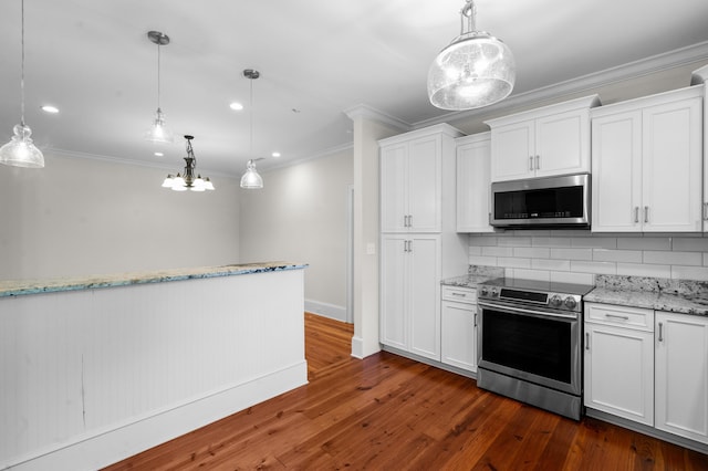kitchen featuring backsplash, white cabinetry, appliances with stainless steel finishes, decorative light fixtures, and dark wood-style floors