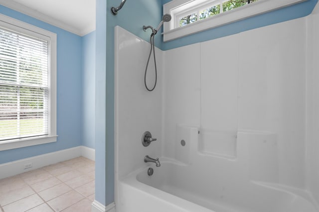 full bath featuring tile patterned floors, tub / shower combination, ornamental molding, and a wealth of natural light