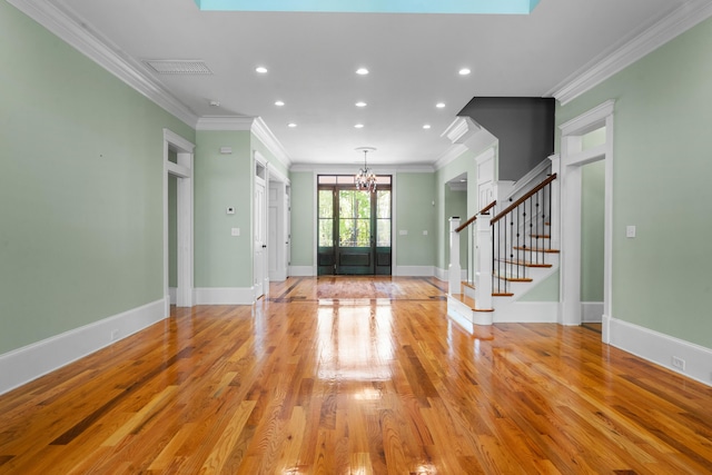 foyer entrance with visible vents, ornamental molding, light wood-type flooring, a chandelier, and recessed lighting
