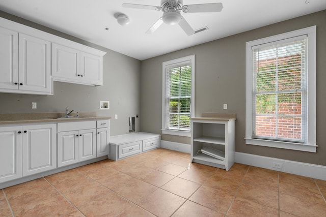 laundry area featuring visible vents, washer hookup, a sink, ceiling fan, and cabinet space