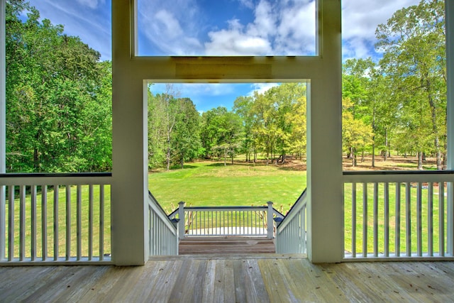 wooden terrace featuring a yard