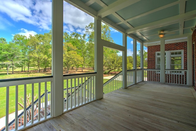 wooden terrace featuring a yard