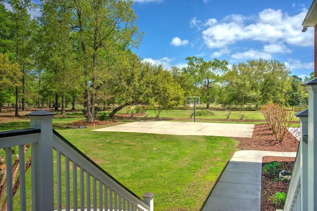 view of yard featuring basketball hoop