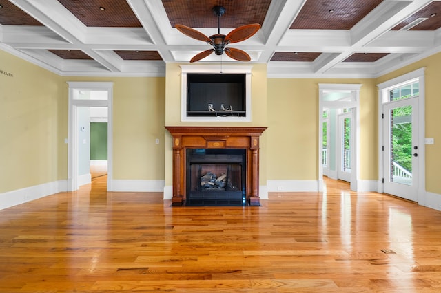 unfurnished living room featuring baseboards, ceiling fan, beam ceiling, a fireplace with flush hearth, and light wood-style flooring