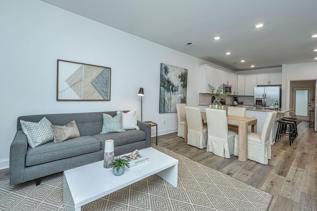 902 Twin Rivers Dr, Wando, SC 29492 - living room with recessed lighting, baseboards, visible vents, and light wood-style flooring