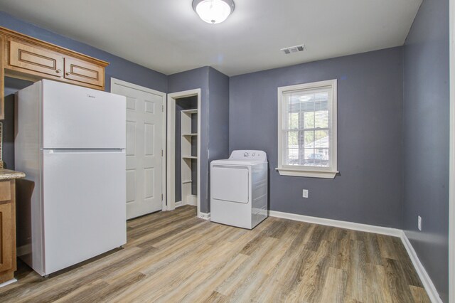 washroom featuring light wood-type flooring and washer / dryer