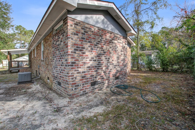 view of side of home featuring central AC